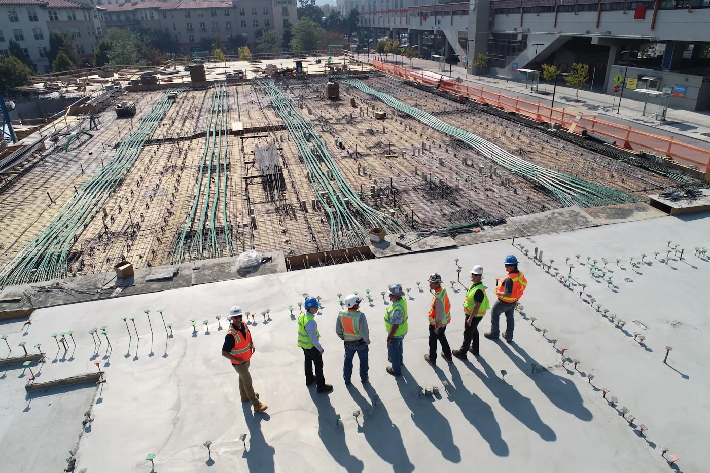 Aerial view of a construction site with crew and heavy groundwork underway
