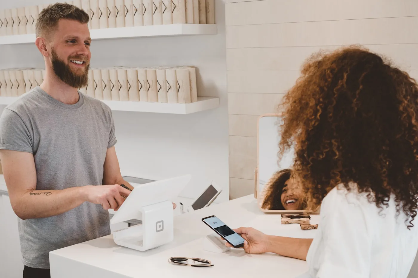 Online store owner taking payment at a retail counter